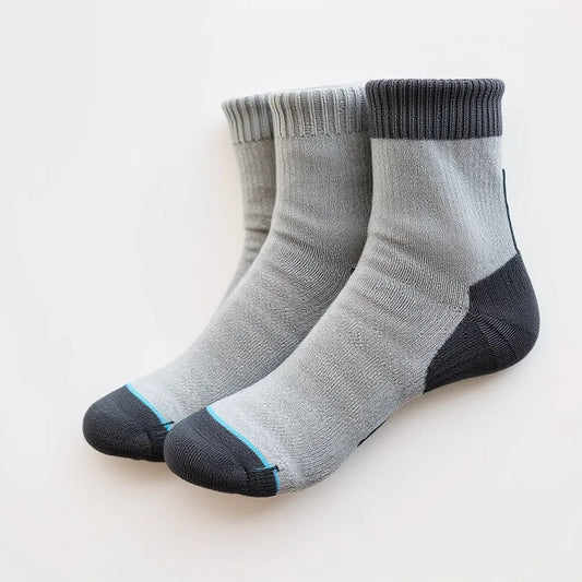 Three pairs of grip socks arranged neatly, showing non-slip textured soles for traction